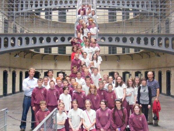 Professional museum guide leading visitors through historic Kilmainham Gaol educational tour