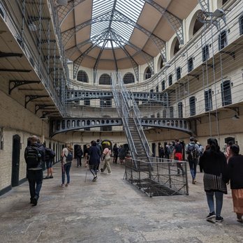 Small tour group experiencing immersive storytelling in Kilmainham prison setting
